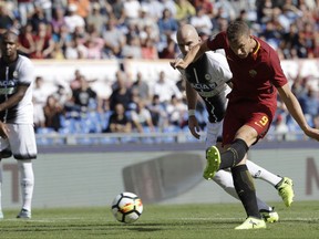 Roma's Edin Dzeko scores a goal during an Italian Serie A soccer match between Roma and Udinese, at the Olympic stadium in Rome, Saturday, Sept. 23, 2017. (AP Photo/Alessandra Tarantino)