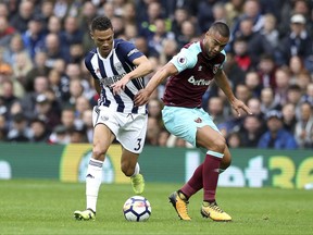 West Bromwich Albion's Kieran Gibbs, left, vies for the ball with West Ham's Winston Reid, during the English Premier League soccer match between West Bromwich Albion and West Ham United, at the Hawthorns, in West Bromwich, England, Saturday, Sept. 16, 2017. (Nick Potts/PA via AP)