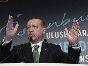 Turkish President Recep Tayyip Erdogan speaks during a meeting in Istanbul, Monday, Sept. 25, 2017. Erdogan is threatening military intervention in Iraq in response to Iraqi Kurdish region's referendum on independence. Erdogan on Monday said Turkey would take political, economic as well as military measures against Iraqi Kurds' steps toward independence and also suggested that Turkey could halt oil flows from a pipeline from northern Iraq. (Pool photo via AP)