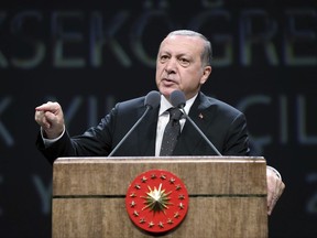 Turkish President Recep Tayyip Erdogan addresses academics at his palace in Ankara, Turkey, Tuesday, Sept. 26, 2017. Erdogan says "attacks" against Turkey by German politicians during their election campaigns has led to an outcome which leaves them unlikely to form a new government for "at least a few months." Erdogan said Tuesday that the Netherlands was similarly not able to form a government because Dutch politicians had "attacked us over and over again." (Pool photo via AP)