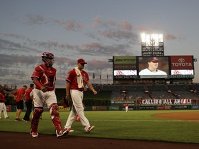 Los Angeles Angels catcher Martin Maldonado, left, and starting pitcher Garrett Richards walk to the dugout before a baseball game against the Houston Astros in Anaheim, Calif., Tuesday, Sept. 12, 2017. (AP Photo/Chris Carlson)