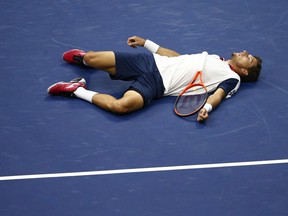 Pablo Carreno Busta lies on the court after missing a shot against Kevin Anderson at the U.S. Open on Sept. 8.