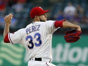 Texas Rangers starting pitcher Martin Perez (33) throws to the Seattle Mariners in the first inning of a baseball game, Wednesday, Sept. 13, 2017, in Arlington, Texas. (AP Photo/Tony Gutierrez)