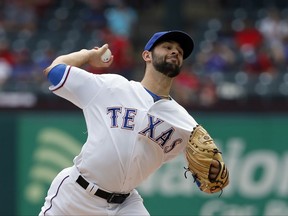 Texas Rangers starting pitcher Nick Martinez throws to the Houston Astros in the first inning of a baseball game, Wednesday, Sept. 27, 2017, in Arlington, Texas. (AP Photo/Tony Gutierrez)