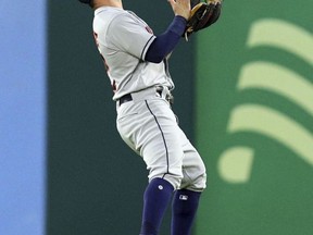 Houston Astros second baseman Jose Altuve catches a fly ball by Texas Rangers' Adrian Beltre in the first inning of a baseball game Monday, Sept. 25, 2017, in Arlington Texas. (AP Photo/Richard W. Rodriguez)