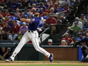Texas Rangers' Joey Gallo follows through on a double as Seattle Mariners' Mike Zunino watches during the fourth inning of a baseball game, Thursday, Sept. 14, 2017, in Arlington, Texas. (AP Photo/Tony Gutierrez)