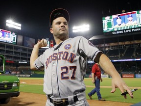 Houston Astros second baseman Jose Altuve (27) throws a ball back to a fan after signing it after their baseball game against the Texas Rangers on Tuesday, Sept. 26, 2017, in Arlington, Texas. The Astros won 14-3. (AP Photo/Tony Gutierrez)