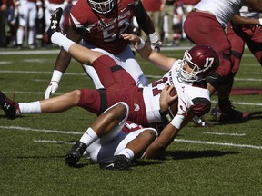 New Mexico State quarterback Tyler Rogers is sacked by Arkansas defender Dwayne Eugene Jr. during the first half of an NCAA college football game in Fayetteville, Ark., Saturday, Sept. 30 2017. (AP Photo/Michael Woods)