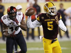 Arizona State quarterback Manny Wilkins (5) looks to throw a pass as San Diego State's Randy Ricks (40) applies pressure during the first half of an NCAA college football game Saturday, Sept. 9, 2017, in Tempe, Ariz. (AP Photo/Ross D. Franklin)