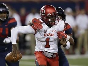 Arizona linebacker Tony Fields II tackles Utah quarterback Tyler Huntley (1) during the first half during an NCAA college football game, Friday, Sept. 22, 2017, in Tucson, Ariz. Huntley left the game with an injury. (AP Photo/Rick Scuteri)