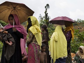 Myanmar's Rohingya ethnic minority refugee women and children look for shelters after crossing the border near Cox's Bazar's Gundum area, Bangladesh, Sunday, Sept. 3, 2017. Aid officials said relief camps were reaching full capacity as thousands of Rohingya refugees continued to pour into Bangladesh on Sunday fleeing violence in western Myanmar. Some 73,000 people have crossed the border since violence erupted Aug. 25 in Myanmar's Rakhine state, said U.N. High Commissioner for Refugees spokeswoman Vivian Tan. (AP Photo/Bernat Armangue)