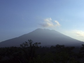 Mount Agung volcano is seen at the sunrise in Bali, Indonesia, Wednesday, Sept. 20, 2017. Indonesia officials have more than doubled the zise of no go zone around the mount Agung volcano o the tourist island of Bali and raised its alert level for the second time in less than a week. (AP Photo/Firdia Lisnawati)