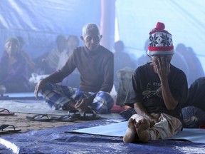 Villagers sit in a temporary shelter in Bali, Indonesia.