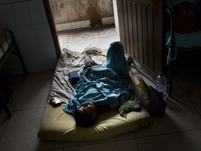 Rohingya men Abdul Karim lies on the floor at Sadar Hospital in Cox's Bazar, Bangladesh, Sunday, Sept. 10, 2017.