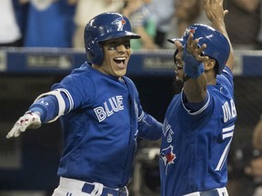 Ryan Goins, left, celebrates his grand slam homer against the New York Yankees with Blue Jays teammate Richard Urena in the sixth inning of their game in Toronto on Friday night.