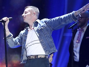 In this Sept. 23, 2017, file photo, Macklemore performs at the 2017 iHeartRadio Music Festival in Las Vegas. U.S. rapper Macklemore is wading into Australia's gay-marriage debate by vowing to sing his marriage equality anthem "Same Love" during a weekend football grand final. (John Salangsang/Invision via AP, File)