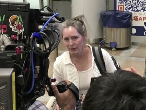 In this image made from video, U.S. citizen and aid worker Heidi Linton of Christian Friends of Korea speaks to reporters after arriving at Beijing International Airport from Pyongyang, North Korea, Thursday, Aug. 31, 2017. A handful of Americans left Pyongyang on a flight to Beijing before the start of a U.S. ban on American citizens going to North Korea. (AP Photo)