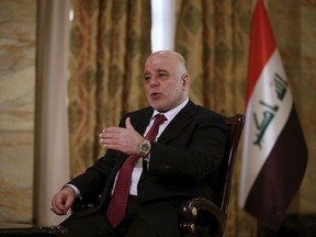 Iraq's Prime Minister Haider al-Abadi speaks during an interview with The Associated Press in Baghdad, Iraq, Saturday, Sept. 16, 2017. Al-Abadi says he is prepared to intervene militarily if the Kurdish region's planned referendum results in violence. (AP Photo/Khalid Mohammed)