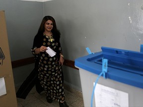 An Iraqi Kurdish woman casts her ballot during the referendum on independence from Iraq in Irbil, Iraq, Monday, Sept. 25, 2017. Iraq's Kurdish region vote in a referendum on whether to secede from Iraq. (AP Photo/Khalid Mohammed)