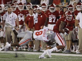 Indiana's Simmie Cobbs Jr. (1) is tackled by Ohio State cornerback Kendall Sheffield during the first half of an NCAA college football game Thursday, Aug. 31, 2017, in Bloomington, Ind. (AP Photo/Darron Cummings)