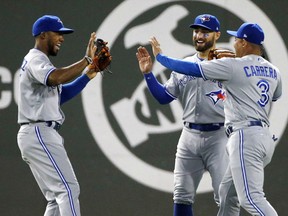 Toronto Blue Jays' Teoscar Hernandez, left, Ezequiel Carrera and Kevin Pillar, centre, celebrate after defeating the Boston Red Sox 6-4 in Boston on Monday.
