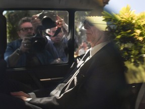 Photographers document the scene as Carlos Nuzman, president of Brazil's Olympic committee, is driven from his home in Rio de Janeiro to Federal Police offices on Sept. 5.