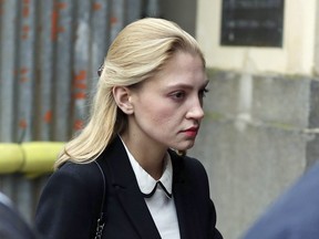 Student Lavinia Woodward arrives at Oxford Crown Court to be sentenced,  in Oxford, England, Monday Sept. 25, 2017. An Oxford University student who stabbed her boyfriend with a bread knife will be able to avoid prison after receiving a suspended sentence.  Woodward was given a 10-month suspended sentence.