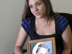 FILE - In a Sept. 17, 2013 file photo, Trista Reynolds holds a photo of her daughter, Ayla Reynolds, during an interview with the Associated Press in Westbrook, Maine. Trista Reynolds asked in a probate court hearing Thursday, Sept. 21, 2017, in Portland, Maine, that her daughter Ayla be declared dead more than five years after her disappearance, so she can file a wrongful death lawsuit against the toddler's father. (AP Photo/Clarke Canfield, File)