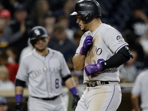 Colorado Rockies' Nolan Arenado reacts at the plate after hitting a solo home run against the San Diego Padres during the fifth inning of a baseball game in San Diego, Friday, Sept. 22, 2017. (AP Photo/Alex Gallardo)