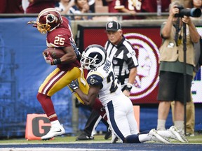 Washington Redskins running back Chris Thompson, left, scores past Los Angeles Rams free safety Lamarcus Joyner during the first half of an NFL football game Sunday, Sept. 17, 2017, in Los Angeles. (AP Photo/Kelvin Kuo)