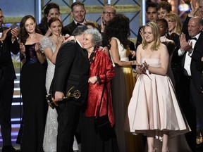 Bruce Miller, from left, Margaret Atwood, and Elisabeth Moss accept the award for outstanding drama series for "The Handmaid's Tale" at the 69th Primetime Emmy Awards on Sunday, Sept. 17, 2017, at the Microsoft Theater in Los Angeles. (Photo by Chris Pizzello/Invision/AP)