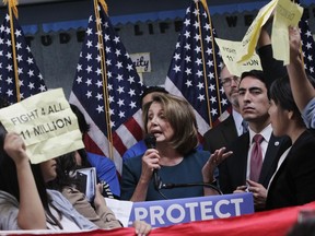 U.S. House Minority Leader Nancy Pelosi tries to talk as protesters demonstrate during a press conference on the DREAM ACT on Monday, Sept. 18, 2017 in San Francisco, Calif. Several dozen young immigrants shouted down Pelosi, the top Democrat in the U.S. House, on Monday during an event in San Francisco, following her recent conversations with President Donald Trump over the future of a program that grants many of them legal status. (Lea Suzuki /San Francisco Chronicle via AP)