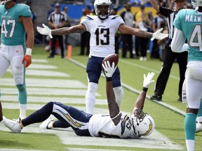 Los Angeles Chargers tight end Antonio Gates, bottom, celebrates his touchdown catch with wide receiver Keenan Allen (13) during the second half of an NFL football game against the Miami Dolphins Sunday, Sept. 17, 2017, in Carson, Calif. With the catch, Gates broke the record previously held by Tony Gonzalez (111) for most touchdown receptions by a tight end in NFL history. (AP Photo/Denis Poroy)