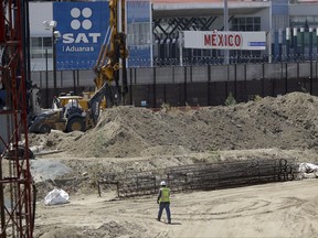 In this Tuesday, Sept. 19, 2017 photo, construction continues on a new curve along California's Interstate 5, as it approaches the border with Tijuana, Mexico, in San Diego. The San Diego to Tijuana border crossing, busiest border crossing in the United States will close this weekend to the more than 40,000 cars that pass through it daily to Mexico. The weekend border closure is to allow for the removal of a large metal canopy spanning over all the southbound lanes into Mexico. (AP Photo/Gregory Bull)