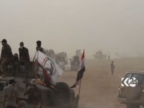 This image made from video provided by Kurdistan 24 shows an Iraqi tank moving into position as forces begun the operation to retake the town of Hawija, Iraq from the Islamic State group Thursday, Sept. 21, 2017. Prime minister Haider al-Abadi says the operation began at dawn in a statement released by his office, just two days after Iraqi forces began an offensive against IS holdouts in Iraq's vast western Anbar province. (Kurdistan 24 via AP)