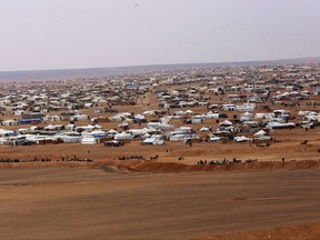 Syrian opposition activists and witnesses say thousands of Syrians stranded on the border with Jordan have fled one makeshift camp for another, running from shelling and nearby fighting between Syrian rebels and government forces. A Jordanian official confirmed Tuesday, Sept. 12, 2017,  that residents of the Hadalat camp in the remote desert of southeastern Syria "were moved." Syrian activists say the last residents fled Hadalat last week, with most heading the larger border camp of Rukban. (AP Photo/Raad Adayleh, File)