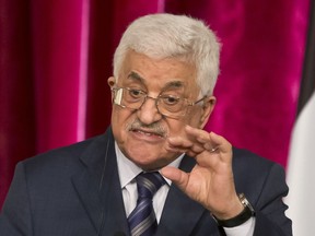 FILE - In this Sept. 19, 2014 file photo, Palestinian President Mahmoud Abbas gestures as he speaks during a media conference at the Elysee Palace in Paris. The Hamas militant group on Sunday, Sept. 7, 2017, said it has accepted key conditions demanded by its rival, President Mahmoud Abbas, including nationwide elections in the West Bank and Gaza Strip, to clear the way for a reconciliation deal after a 10-year rift that has left the Palestinians divided between two governments. (AP Photo/Michel Euler, File)