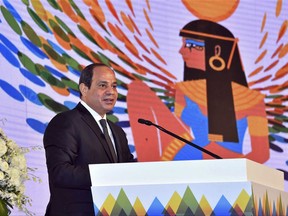 In this photo provided by Egypt's state news agency, MENA, Egyptian President Abdel-Fattah el-Sissi speaks at a financial conference in Sharm el-Sheikh, Egypt, Thursday, Sept. 14, 2017. El-Sissi said Thursday that the government aims to bring down the inflation rate by more than half in 2018, forecasting an improving economy after years of political unrest. (MENA via AP)