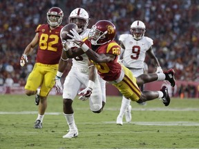Southern California's Deontay Burnett, center, catches a touchdown pass during the first half of an NCAA college football game against Stanford, Saturday, Sept. 9, 2017, in Los Angeles. (AP Photo/Jae C. Hong)