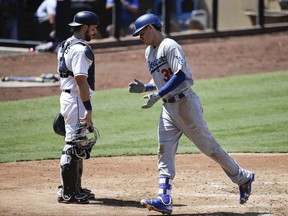 Los Angeles Dodgers' Cody Bellinger, right, celebrates his home run as he heads to the dugout past San Diego Padres catcher Austin Hedges during the fourth inning of a baseball game, Saturday, Sept. 2, 2017, in San Diego. (AP Photo/Jae C. Hong)