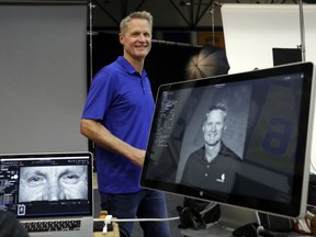 Golden State Warriors head coach Steve Kerr smiles after posing for photographs during NBA basketball team media day Friday, Sept. 22, 2017, in Oakland , Calif. (AP Photo/Marcio Jose Sanchez)