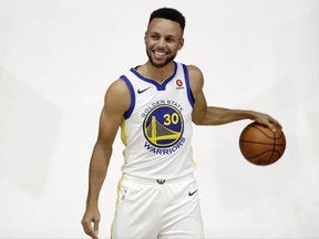 Golden State Warriors' Stephen Curry poses for photos during NBA basketball team media day Friday, Sept. 22, 2017, in Oakland, Calif. (AP Photo/Marcio Jose Sanchez)