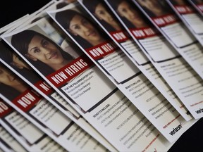 In this Thursday, Aug. 24, 2017, photo, flyers advertise jobs for Verizon during a job fair in San Jose, Calif. On Thursday, Sept. 7, 2017, the Labor Department reports on the number of people who applied for unemployment benefits a week earlier. (AP Photo/Marcio Jose Sanchez)