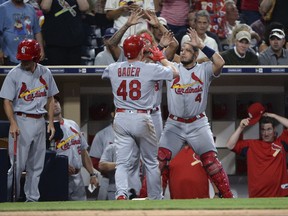 St. Louis Cardinals' Harrison Bader is congratulated at the dugout by Yadier Molina after hitting a three-run home run during the second inning of a baseball game against the San Diego Padres on Tuesday, Sept. 5, 2017, in San Diego. (AP Photo/Orlando Ramirez)