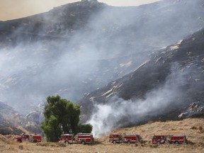 The Marlborough fire races up a hill from where it started on Thursday, Aug. 31, 2017 in Riverside. (Stan Lim/The Press-Enterprise via AP)
