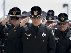 Sacramento County Deputies salute the casket of their fallen comrade, Sacramento Deputy Robert French, 52, outside Bayside at Adventure Christian Church on Thursday, Sept. 7, 2017 in Roseville, Calif. Approximately 3,000 law enforcement officers attended the memorial service to honor French who was shot and killed last week during an auto theft investigation.  (Randy Pench/The Sacramento Bee via AP)