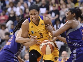 Los Angeles Sparks' Candace Parker (3) is fouled by Phoenix Mercury's Monique Curry (25) as Mercury's Camille Little helps on defense during the first half of Game 2 of WNBA basketball playoff semifinal, Thursday, Sept. 14, 2017, in Long Beach, Calif. (Stephen Carr//Los Angeles Daily News via AP)