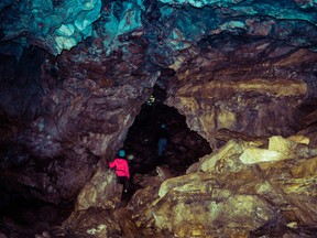 File photo of a person spelunking in a cave. After becoming separated from his group, Lukas Cavar found himself locked in Sullivan Cave near Bloomington, Ind.