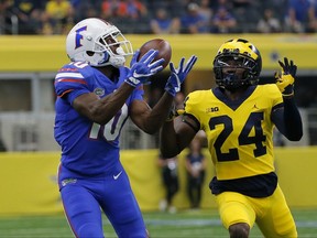 Florida wide receiver Josh Hammond (10) catches a long pass in front of Michigan cornerback Lavert Hill (24) in the first half of an NCAA college football game, Saturday, Sept. 2, 2017, in Arlington, Texas. (AP Photo/Tony Gutierrez)