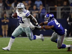 Dallas Cowboys running back Ezekiel Elliott (21) escapes a tackle attempt by New York Giants linebacker B.J. Goodson (93) in the second half of an NFL football game, Sunday, Sept. 10, 2017, in Arlington, Texas. (AP Photo/Ron Jenkins)